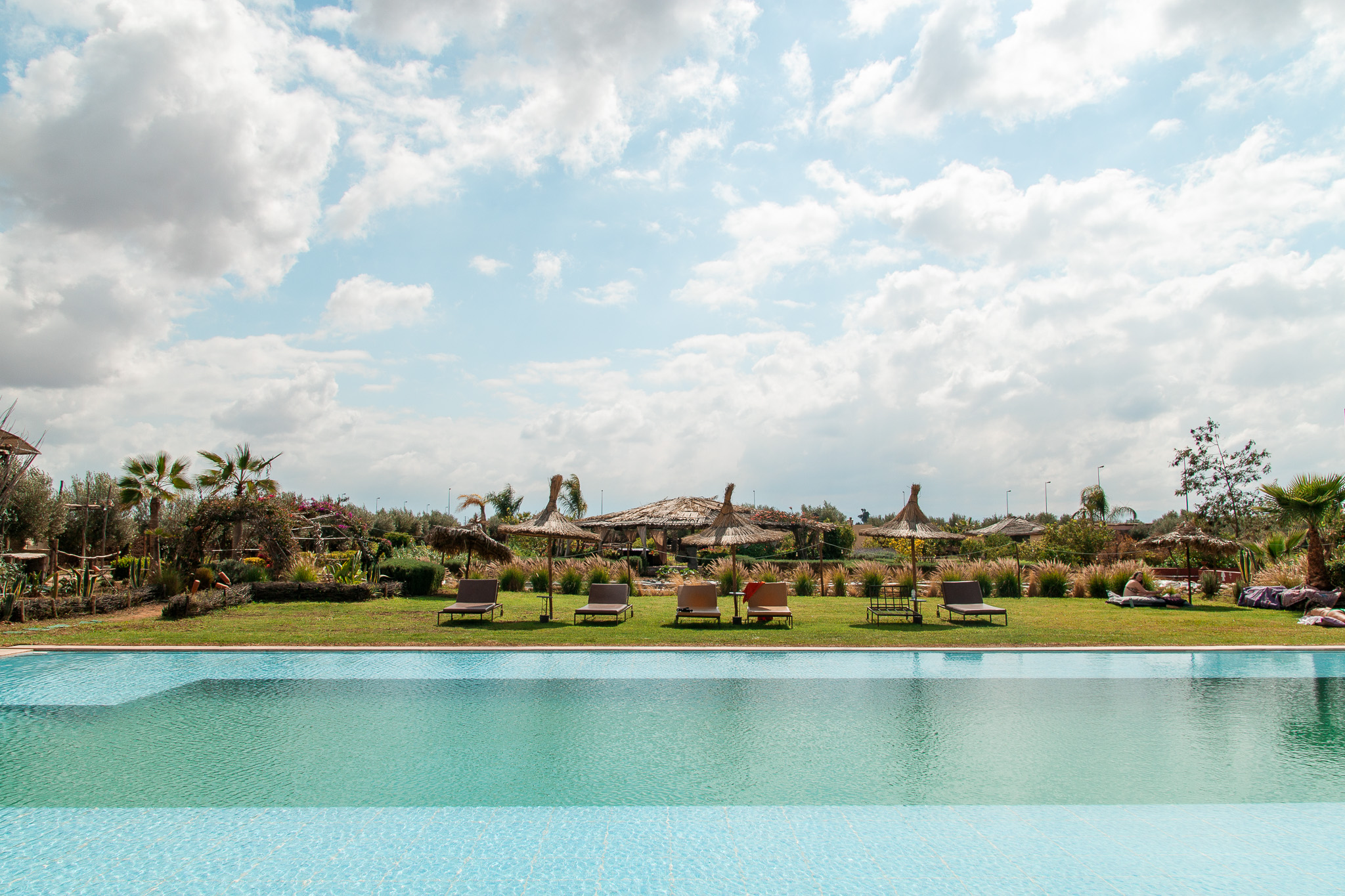 Pool in the Foreground with Mountain views and a sunny sky with a few clounds